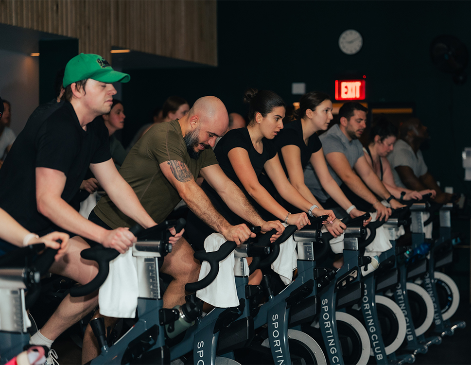 a group of people on exercise bikes