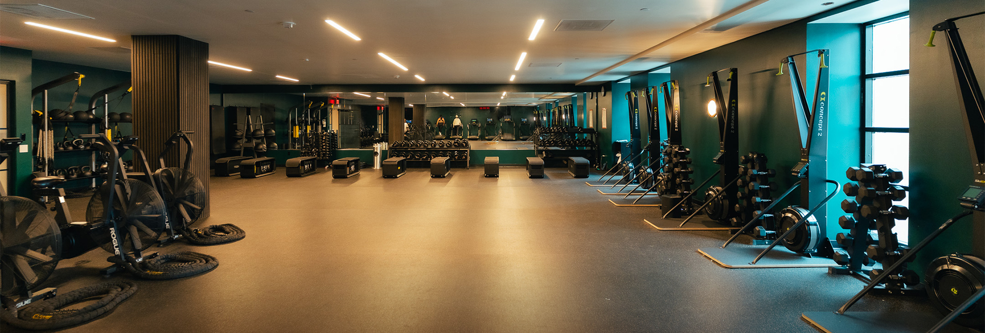 a gym with equipment and a large room