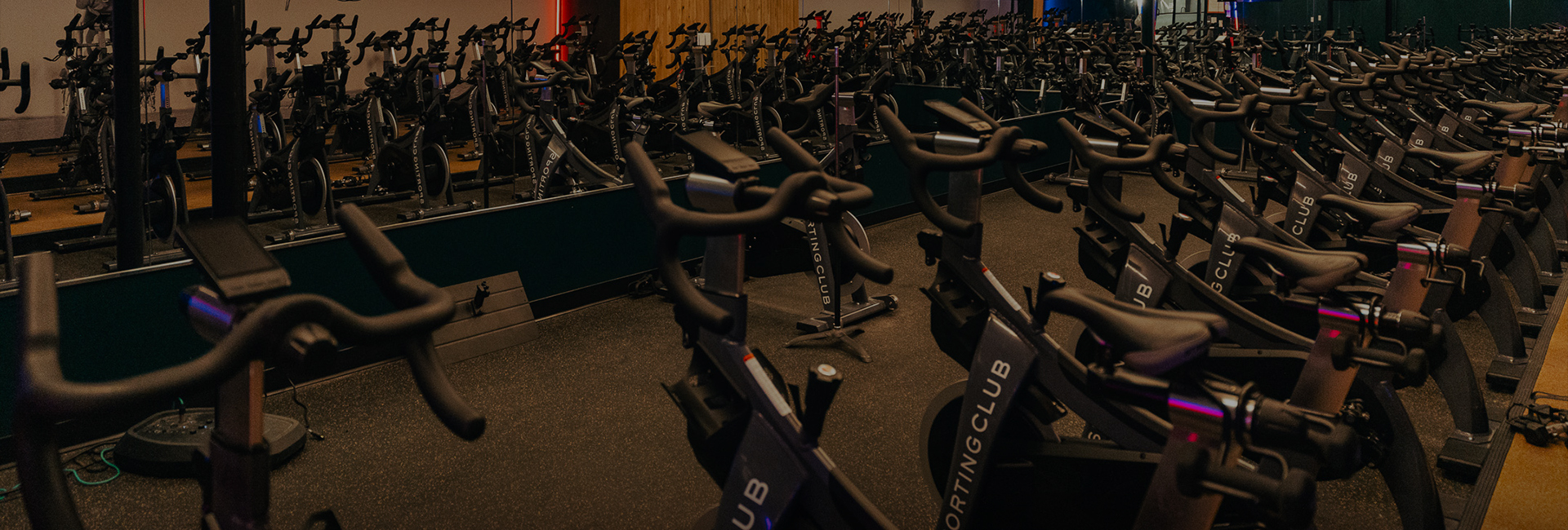 a group of exercise bikes in a gym
