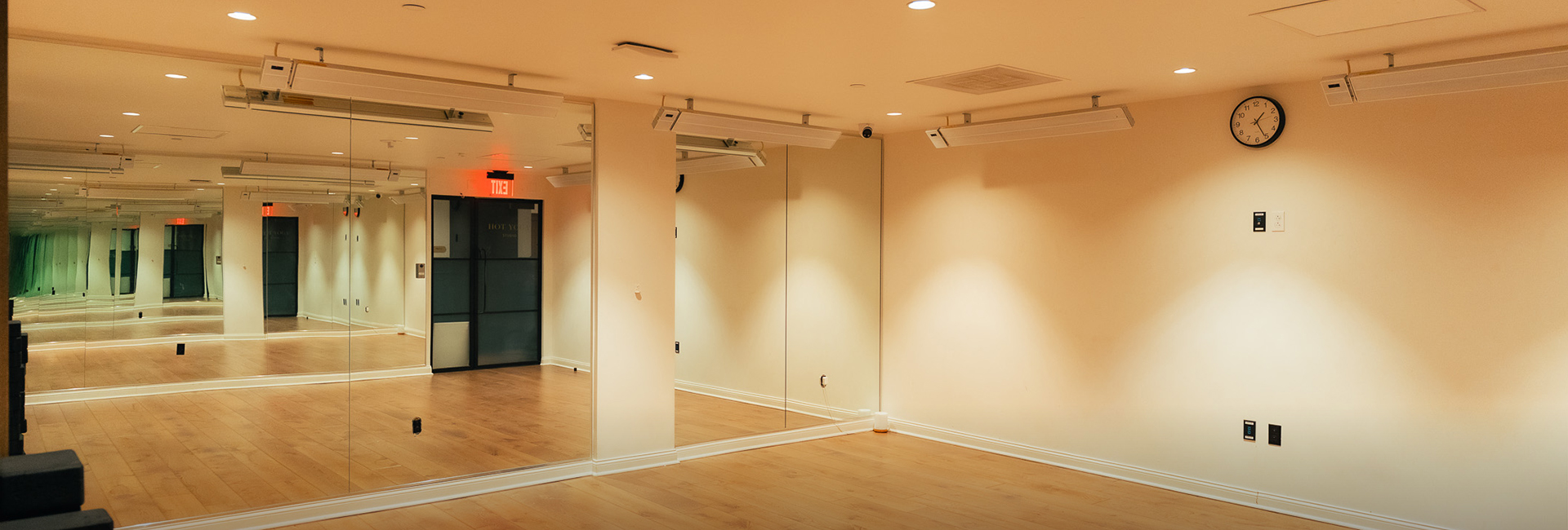 a room with mirrors and wood floors