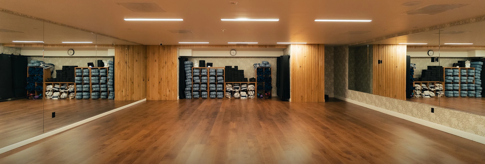 a room with a wood floor and a large room with a wood floor and a wood floor