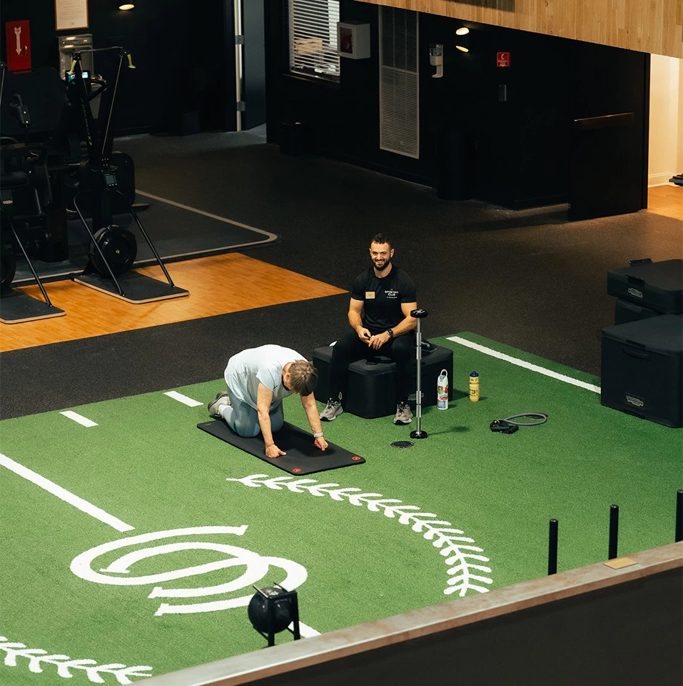 a man on a mat in a gym