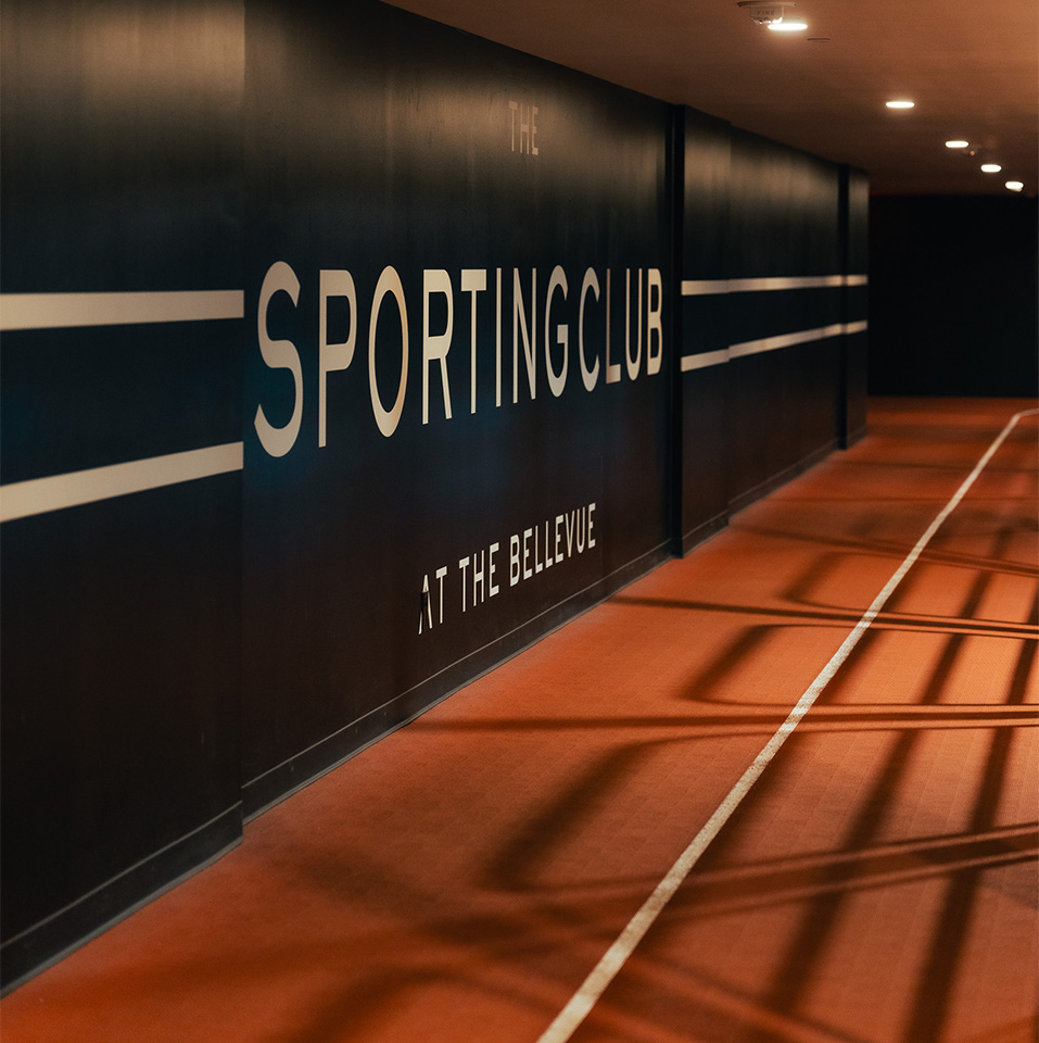 a long hallway with a sign on the wall