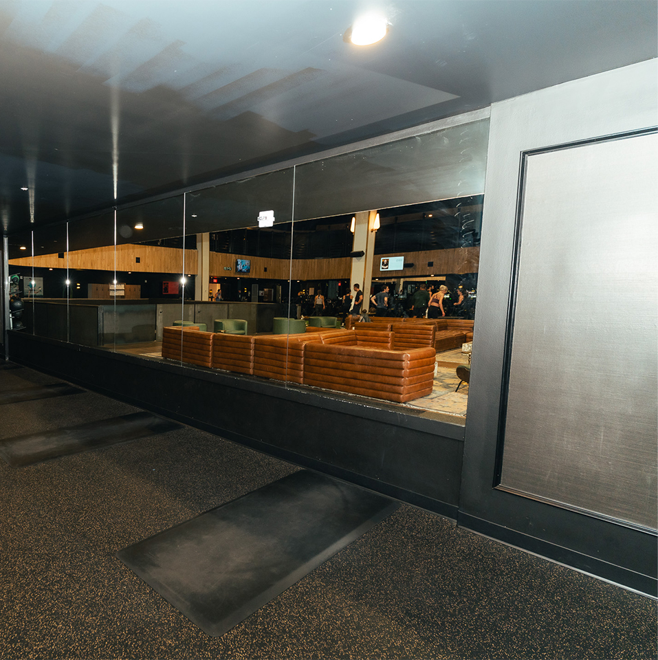 a glass wall with a group of people in the background