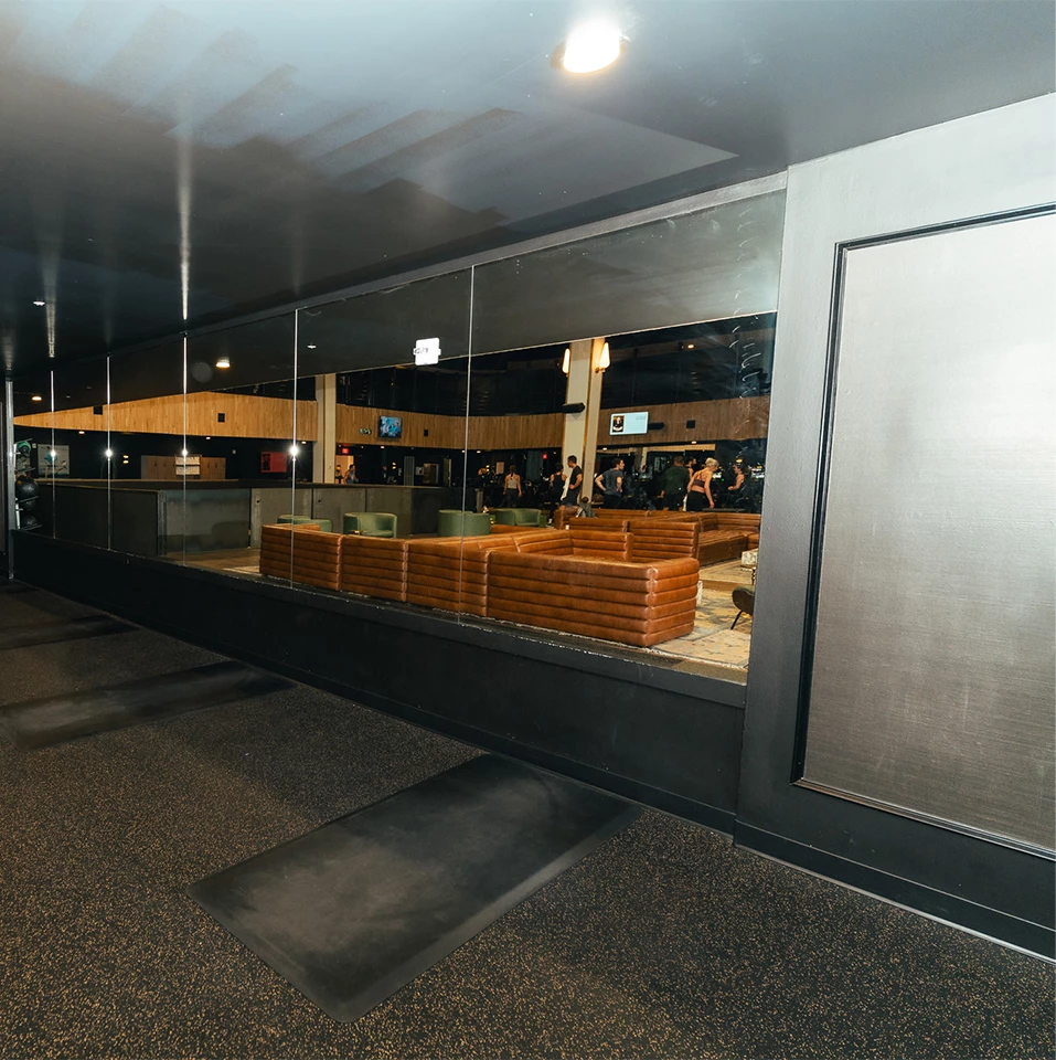 a glass wall with a group of people in the background