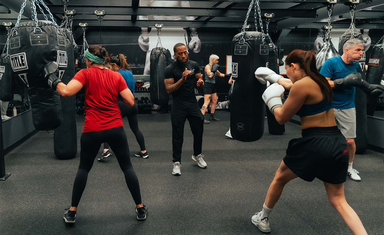 a group of people in a gym boxing