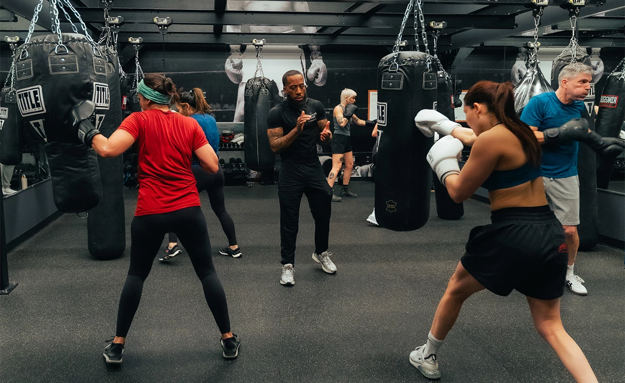 a group of people in a gym boxing