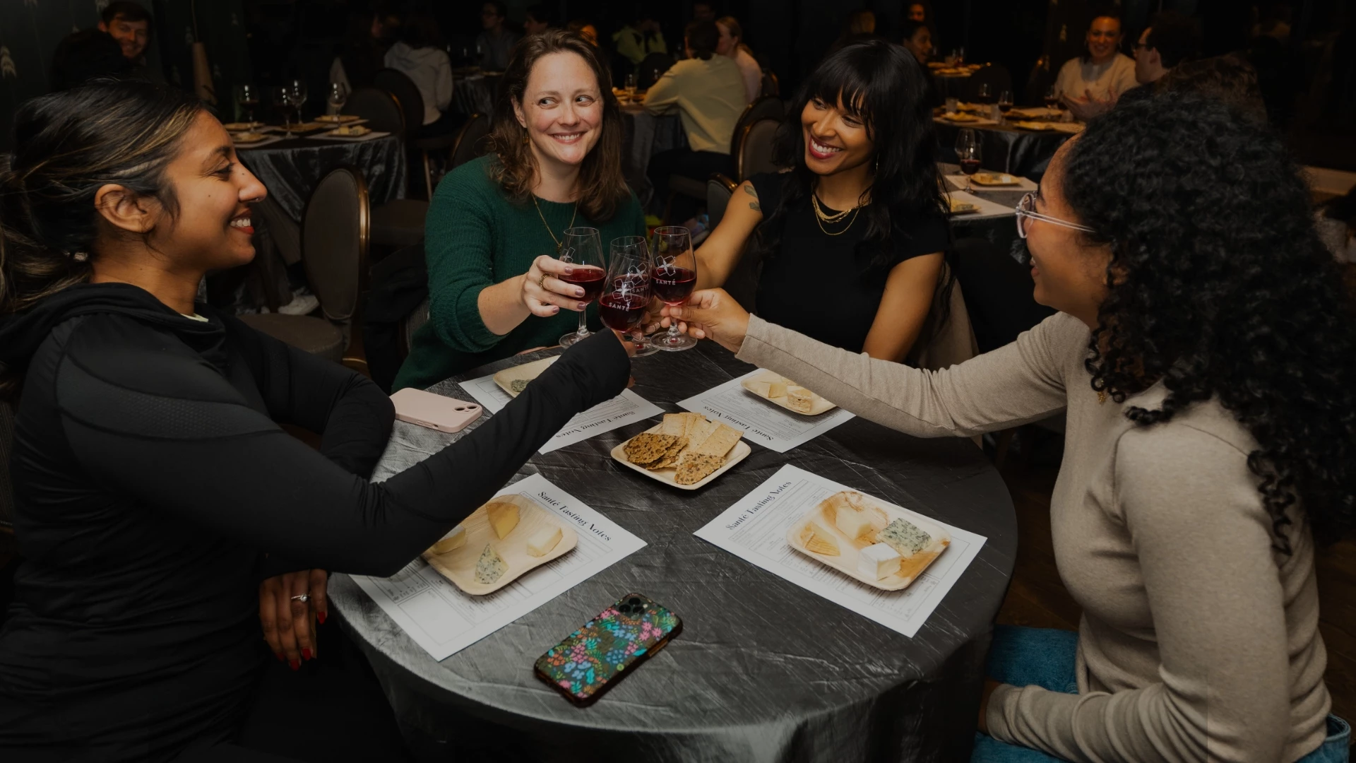 a group of people clinking glasses at a table
