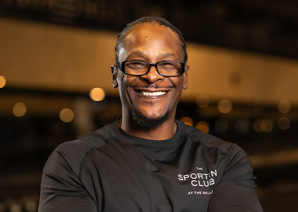 a man wearing glasses smiling