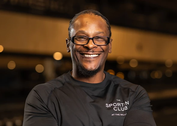 a man wearing glasses smiling