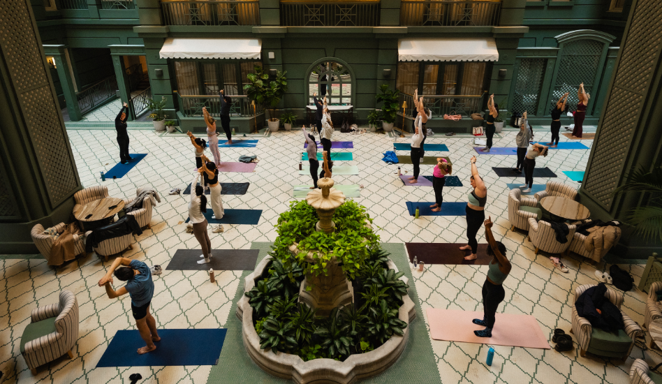 a group of people doing yoga in a courtyard