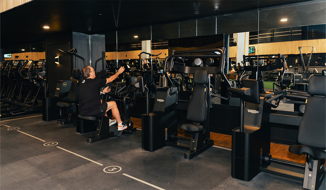 a man on exercise equipment in a gym