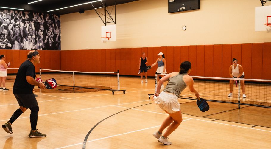 a woman playing tennis in a gym