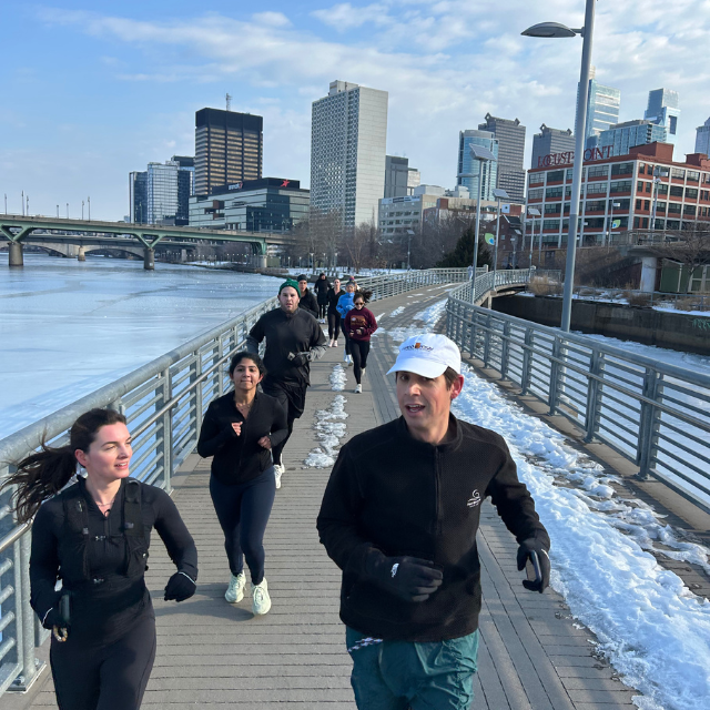 a group of people running on a bridge