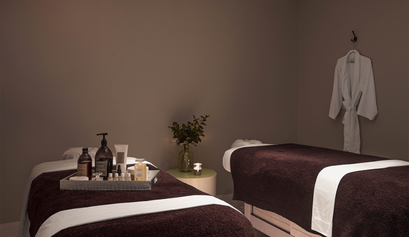 a massage room with a tray of massage products
