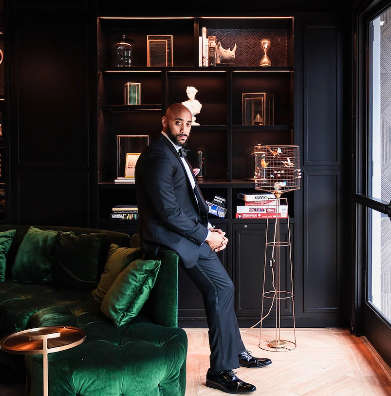 a man in a suit sitting on a couch