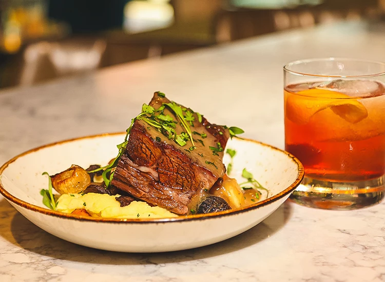 a plate of food and a glass of liquid