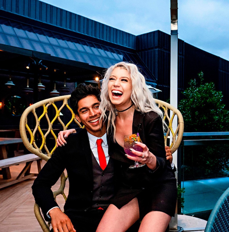 a man and woman sitting on a chair