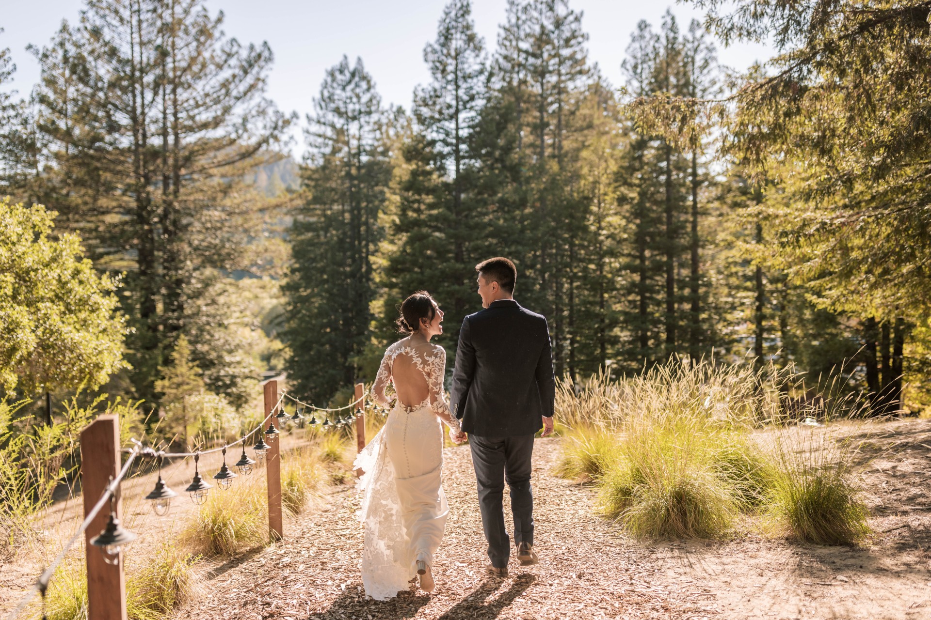 a man and woman walking down a path