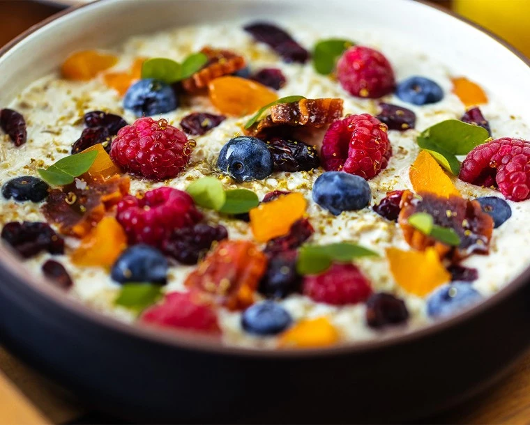 bowl of oats topped with blueberries and raspberries