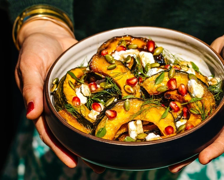 a bowl of food with a person holding it