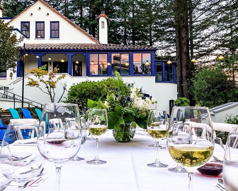 courtyard with table set up and wine glasses