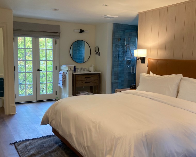 bedroom with wooden panel wall