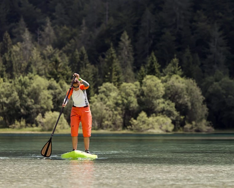 person paddleboarding in a creek