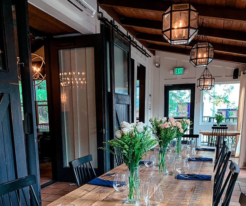 stavrand hall with wooden table and flower center pieces 