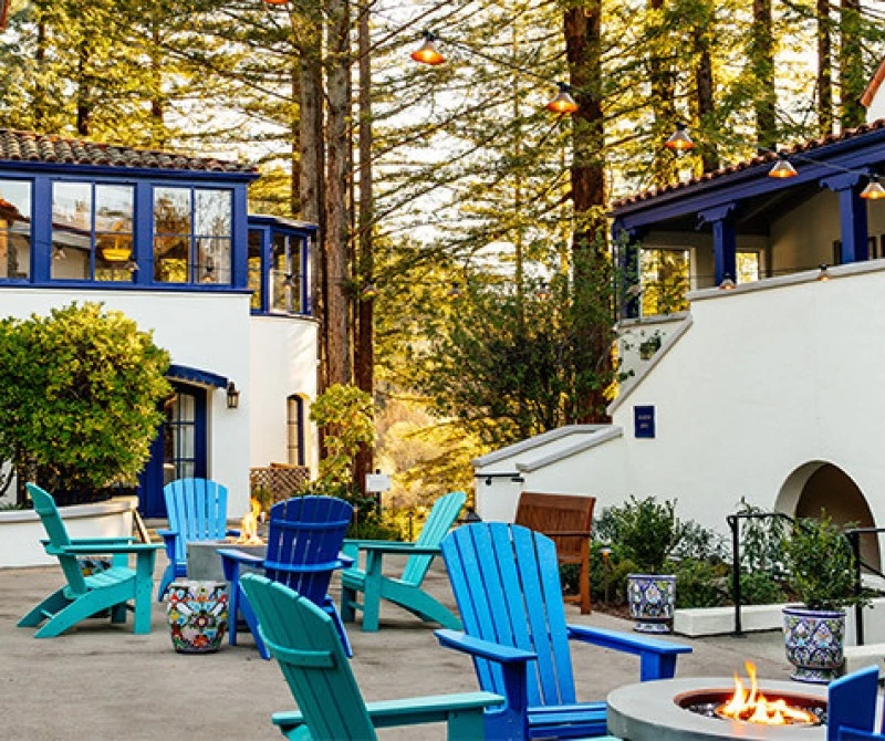 courtyard with campfire surrounded by lawn chairs