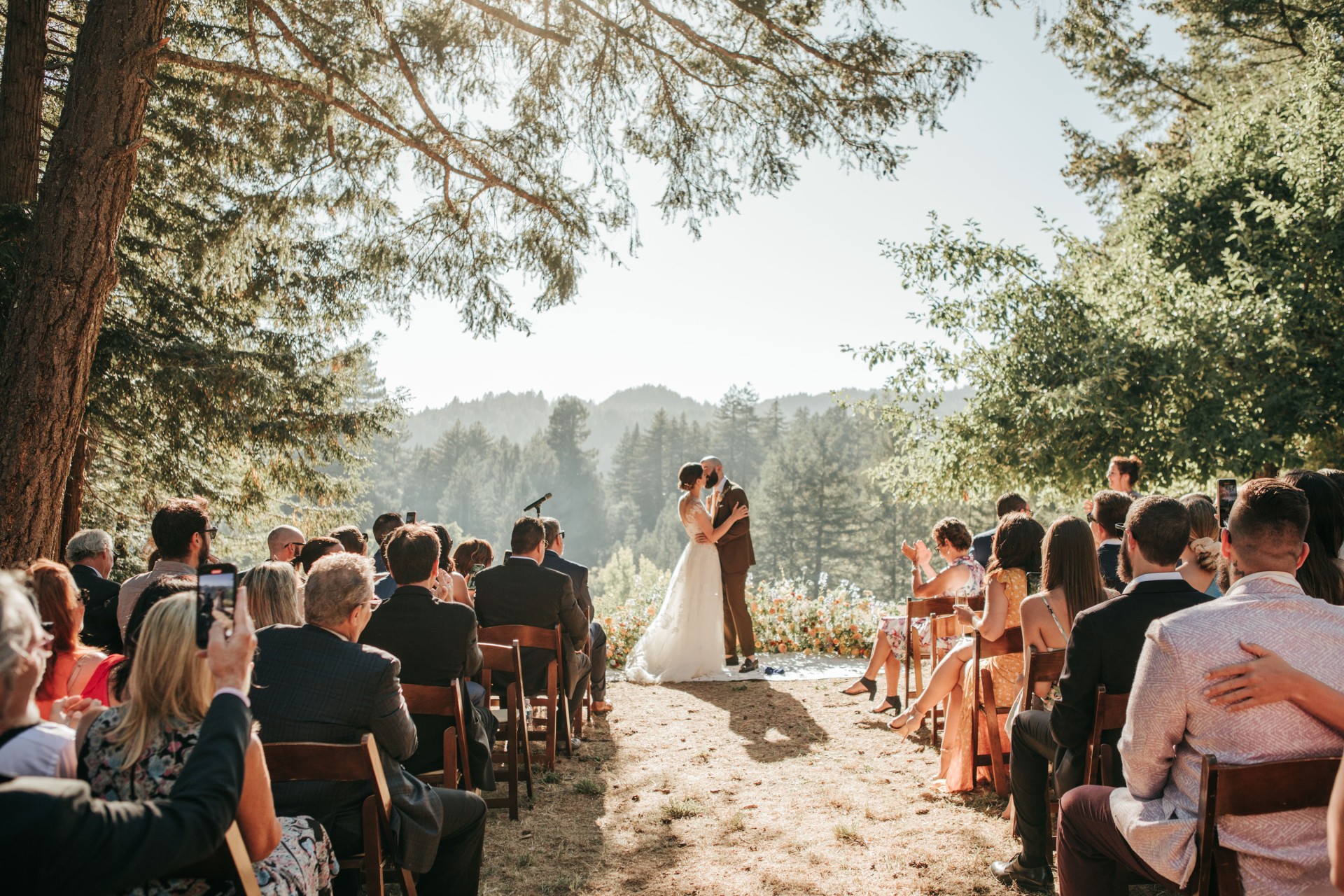 a man and woman in a wedding dress kissing