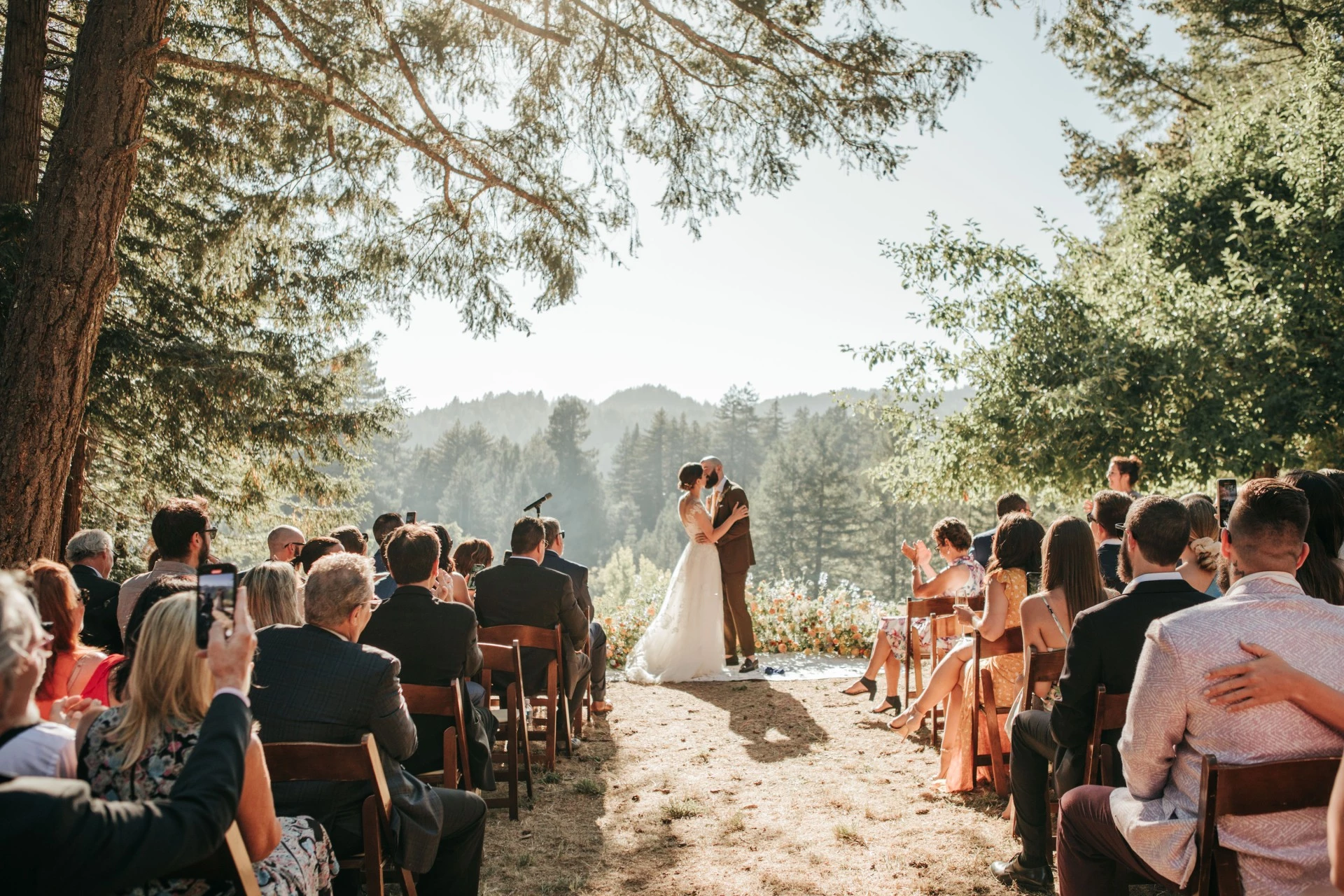 a man and woman in a wedding dress kissing