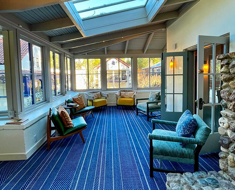 sun room with blue carpet floors 