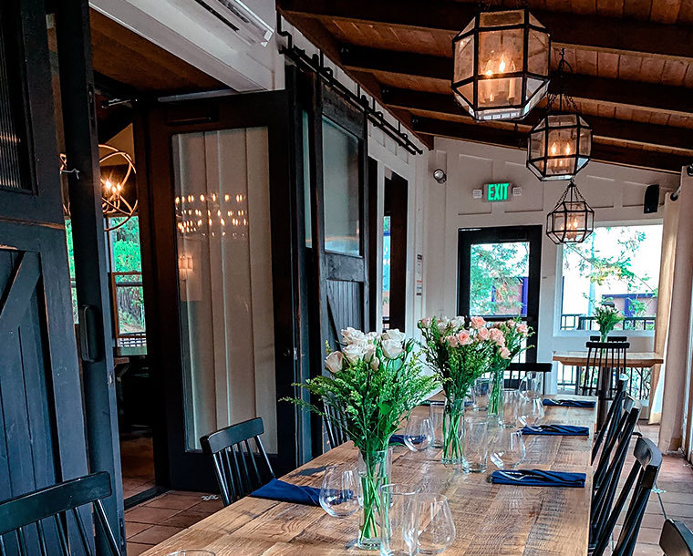 stavrand hall with wooden table and flower center pieces 