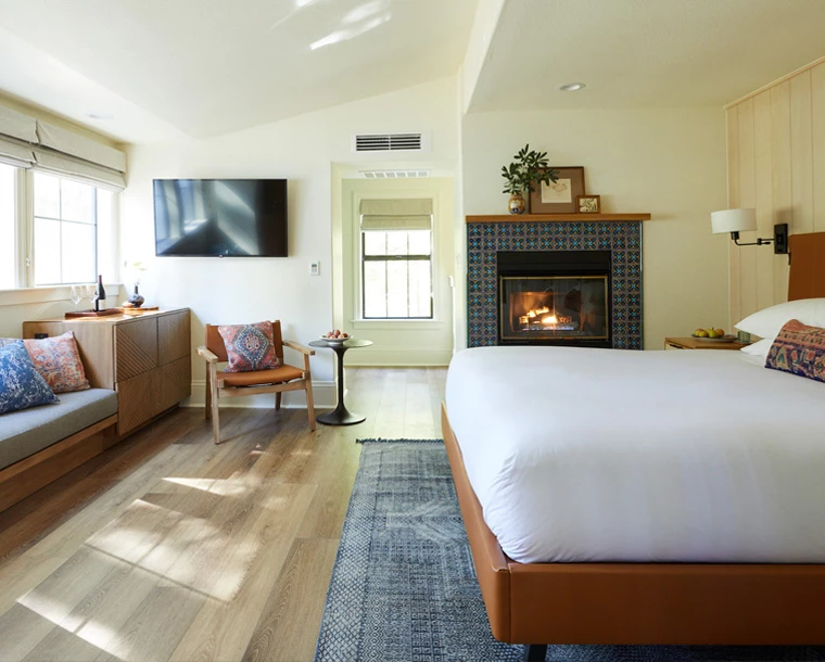 Cazadero guestrroom with fireplace seating and bed