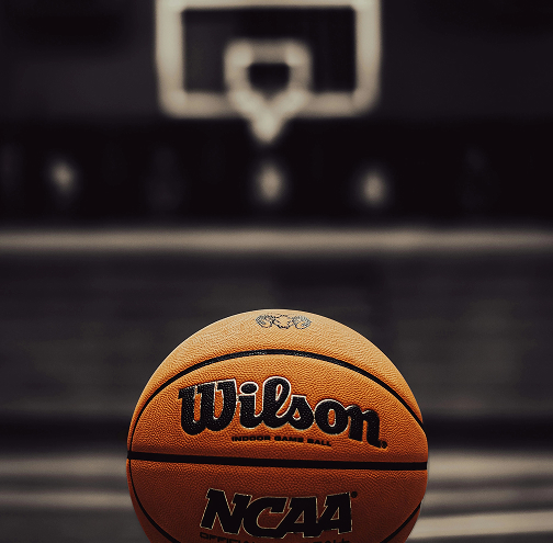 a basketball in front of a basketball hoop