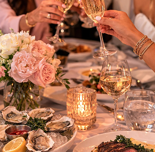 a group of people holding wine glasses
