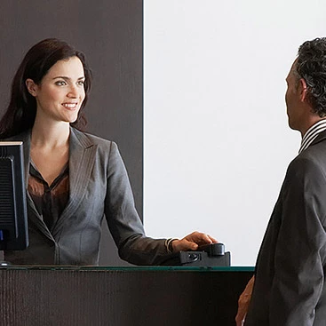 Guest talking to woman at front desk