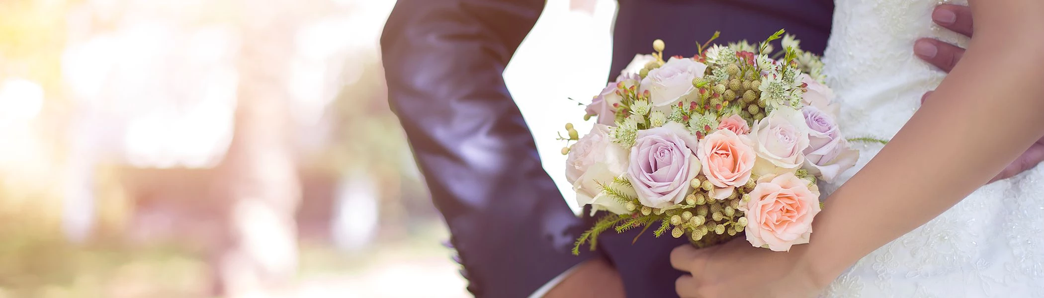 Close up of bride placing hand over grooms hand