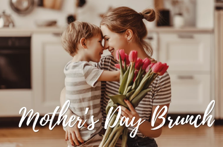 a woman holding a child with flowers