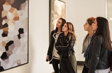 Women looking at artwork in museum