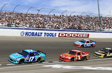 Speedway with race cars & crowd on the bleachers