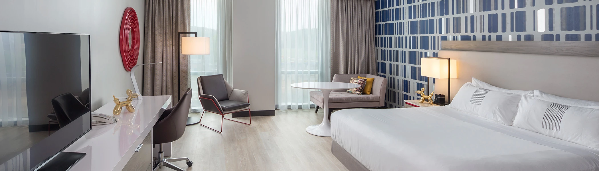 a comfortable and spacious hotel room with a window
