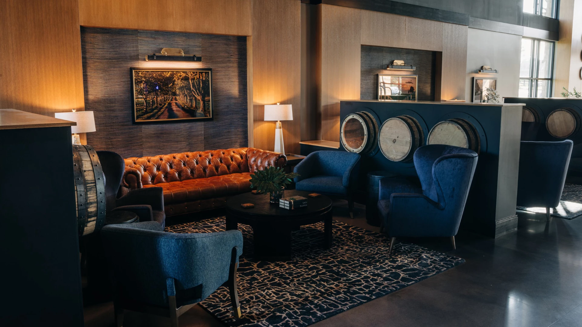 a room with a couch and chairs