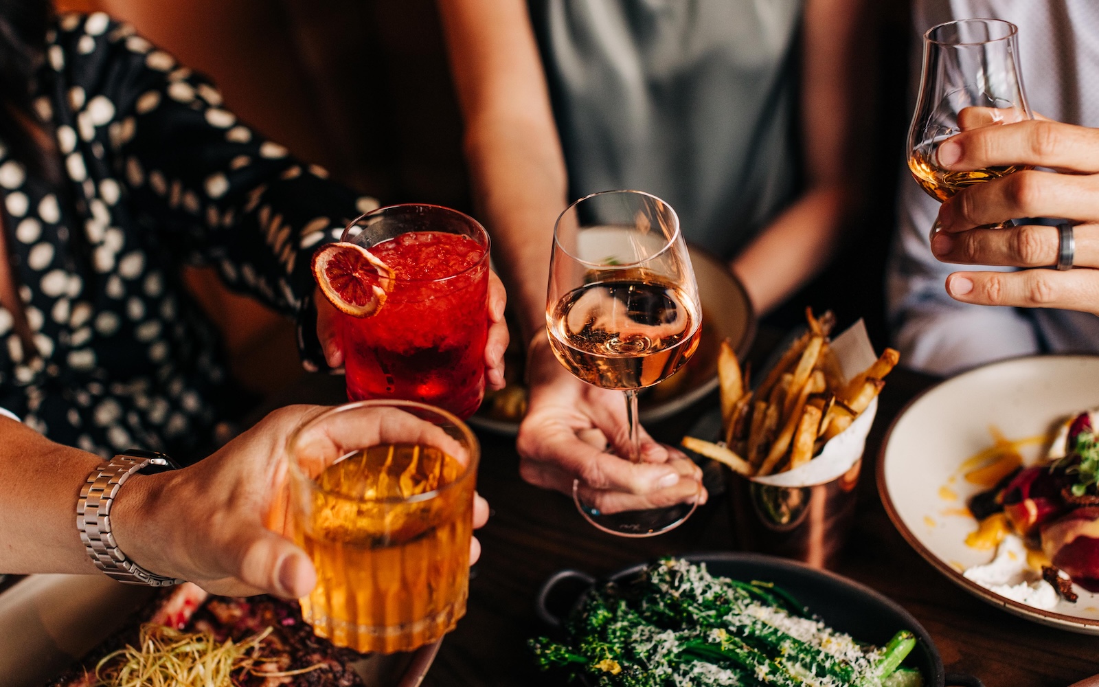 a group of people holding drinks