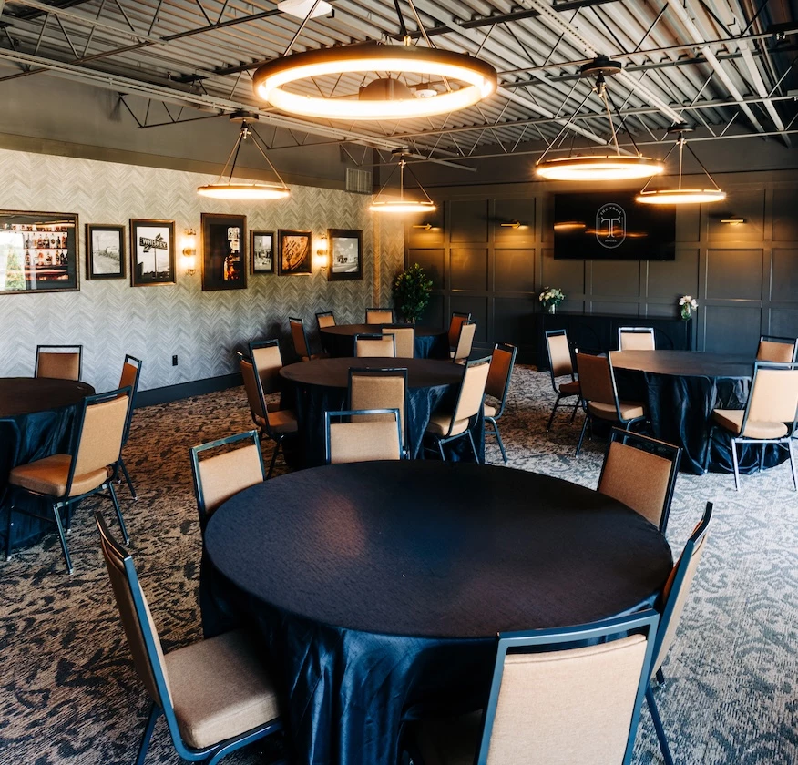 a room with round tables and chairs
