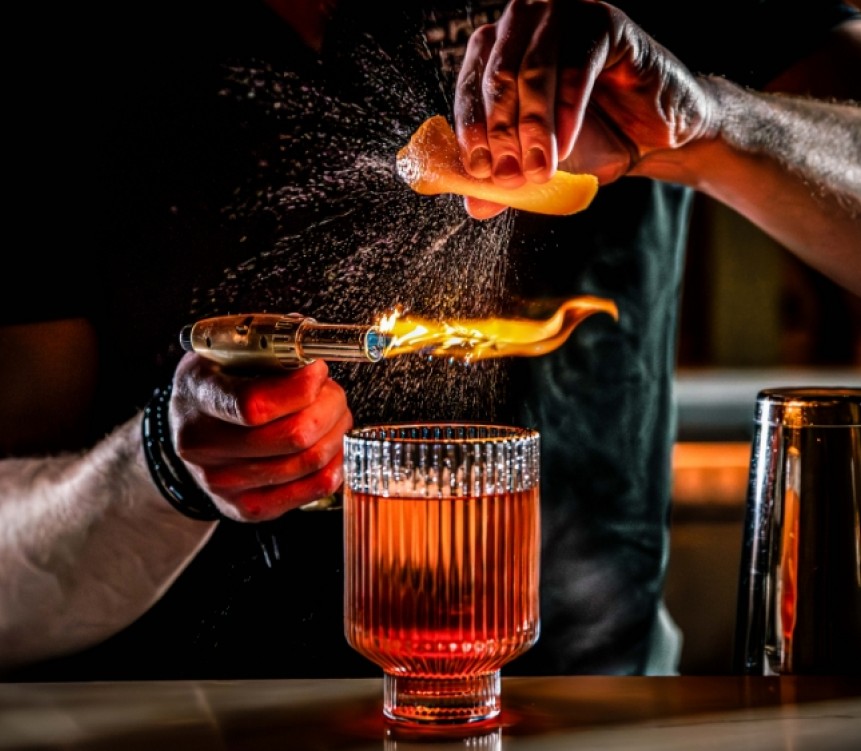 a person pouring a lemon into a glass
