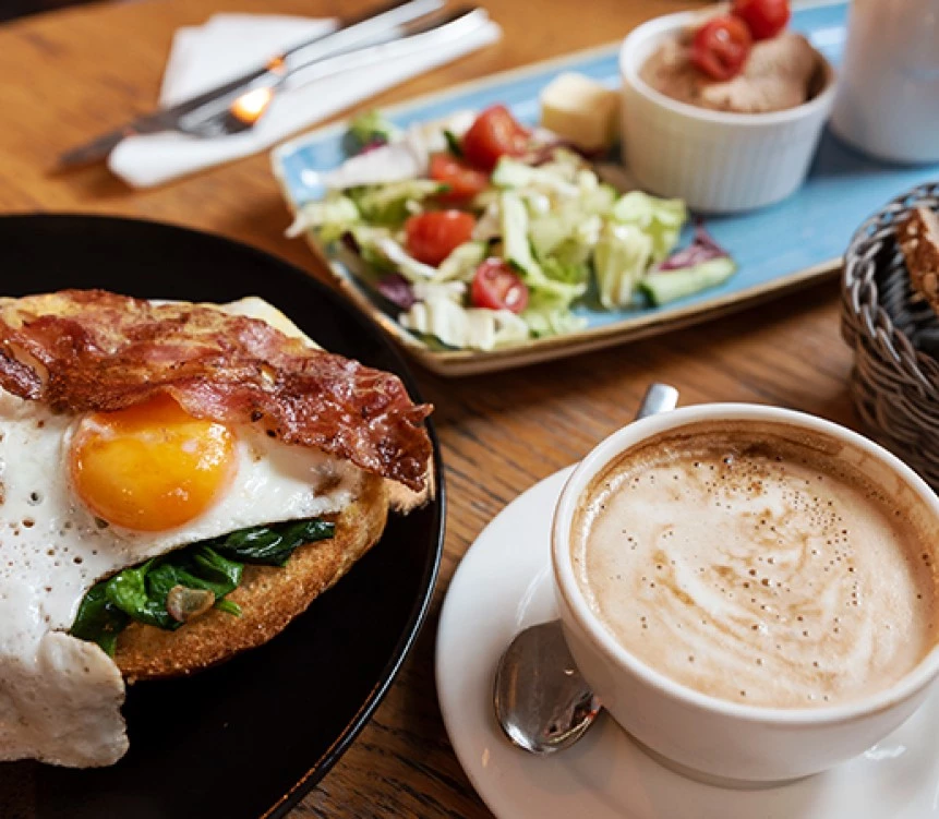 a plate of food and a cup of coffee