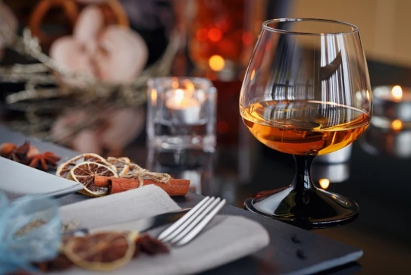 a glass of alcohol on a table