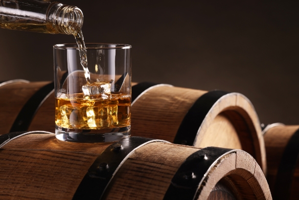 a glass of whiskey being poured into a glass
